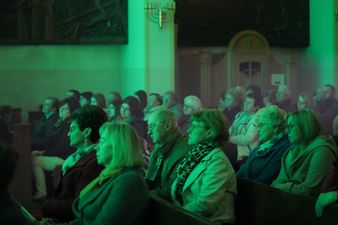 Duża grupa widzów zebrana w ławkach kościelnych