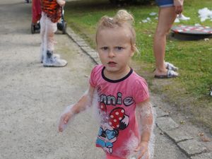 Dziewczynka z uwagą obserwuje przebieg gry zręcznościowej z obręczami