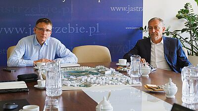 Prezydent Michał Urgoł i I zastępca Grzegorz Dulemba siedzą przy stole na spotkaniu w sprawie strefy centrum na stole makieta