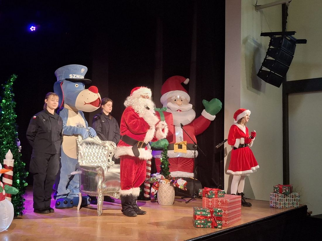 Na scenie Mikołaj, elf, maskotka policji i dwie mundurowe dziewczyny