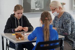 Dzieci wykonujące serce z koralików podczas warsztatów z metaloplstyki