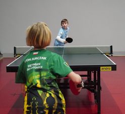 Dwóch chłopców grających w tenisa stołowego