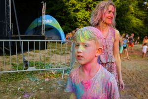 Chłopiec ubrudzony kolorami holi. 