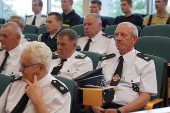 Przedstawiciele służb mundurowych siedzący na sali rady miasta