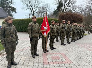 Stojący na baczność z bronia oddział wojska polskiego