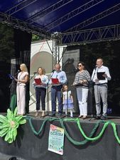 Przedstawiciele samorządu czytają na scenie wierszz "Lokomotywa"