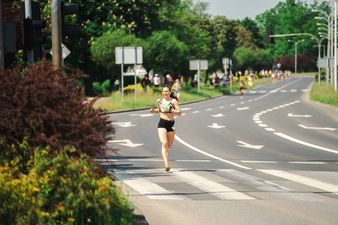 zawodniczka biegnie samotnie po ulicy 