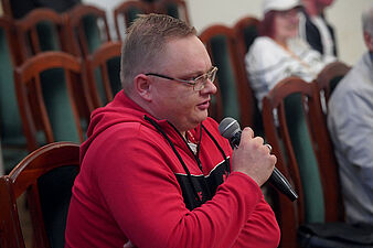 Jeden z uczestników spotkania zadaje pytanie do mikrofonu