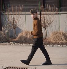 Młody uczestnik gry terenowej ubrany w strój partyzanta