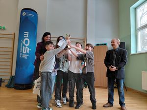 Uczestnicy turnieju wznoszą do góry puchar