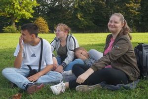 Czworo nastolatków siedzący na trawie podczas pikniku