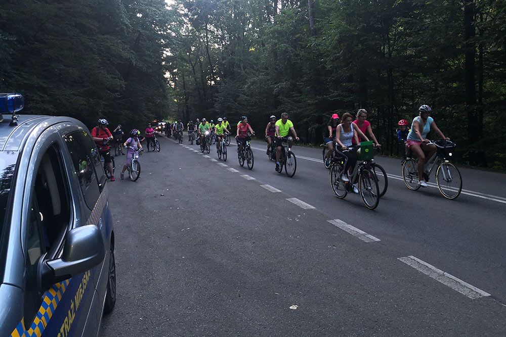 Samochód straży miejskiej zabezpieczający przejazd rowerzystów.