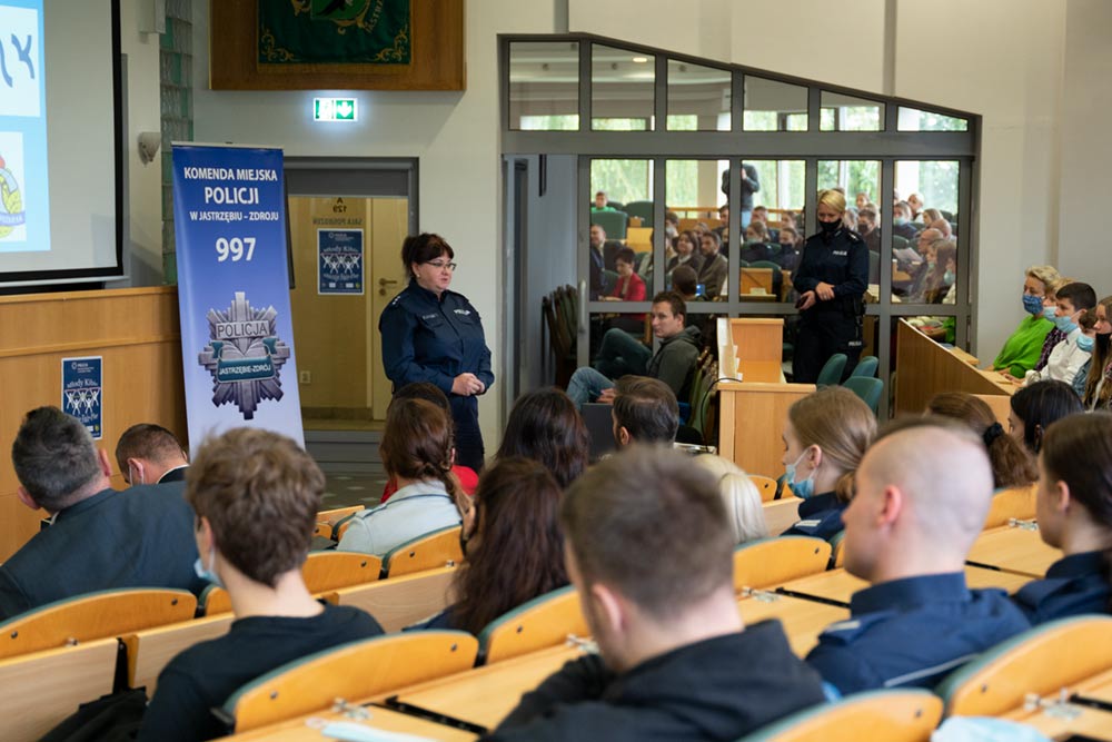 Sala Rady Miasta - młodzież siedzi i słucha prelekcji. Policjantka mówi do nich.